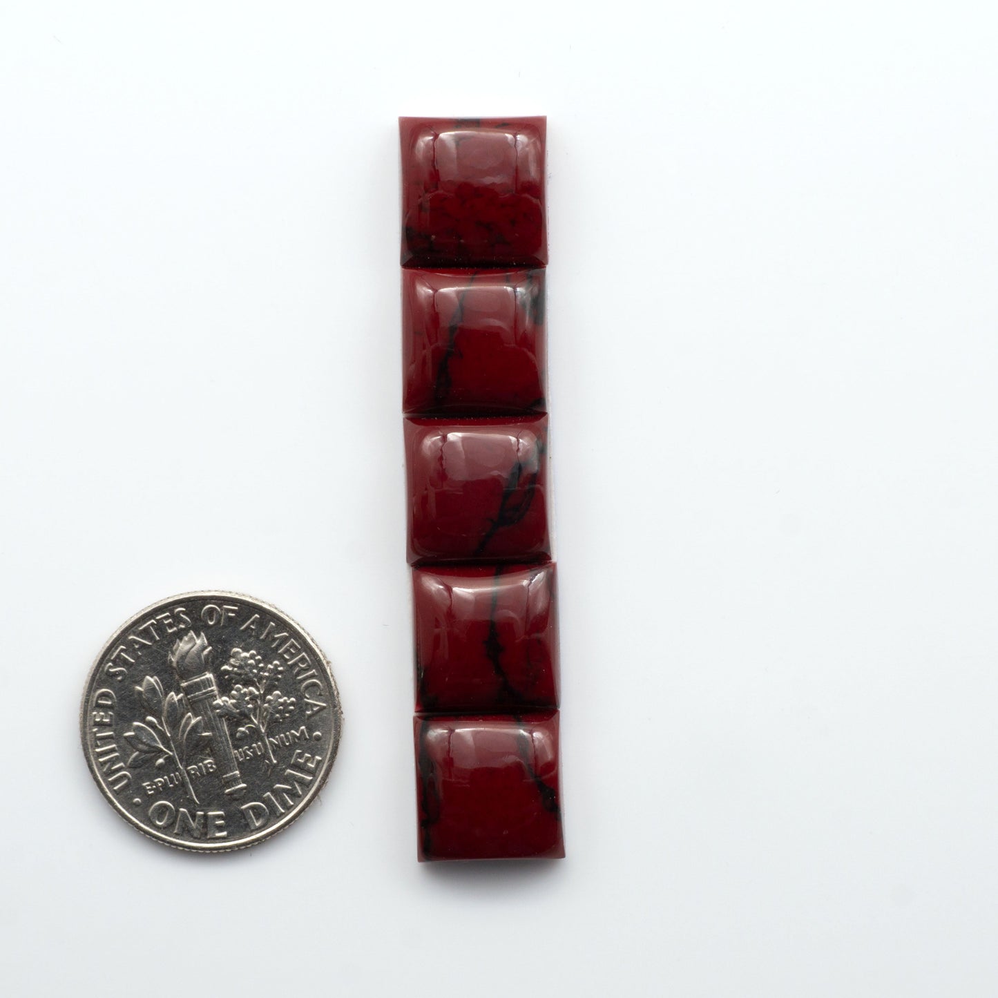 Bloody Bison Jasper is a composite stone with a vibrant red hue and black matrix that creates a strong impression and a touch of opulence to any jewelry piece.