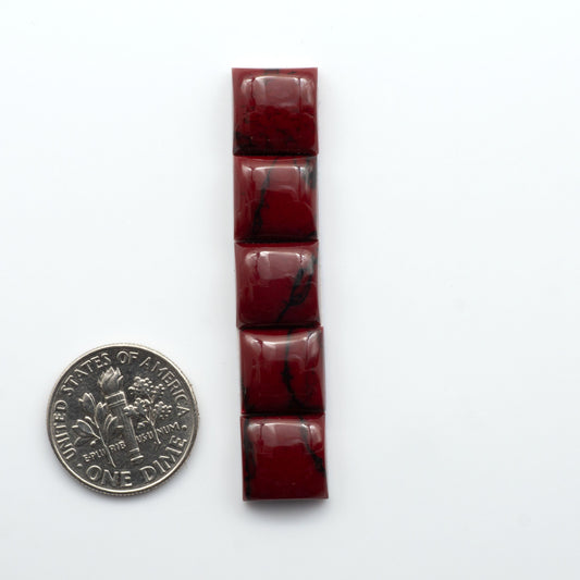 Bloody Bison Jasper is a composite stone with a vibrant red hue and black matrix that creates a strong impression and a touch of opulence to any jewelry piece.