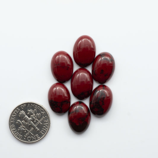 Bloody Bison Jasper is a composite stone with a vibrant red hue and black matrix that creates a strong impression and a touch of opulence to any jewelry piece.