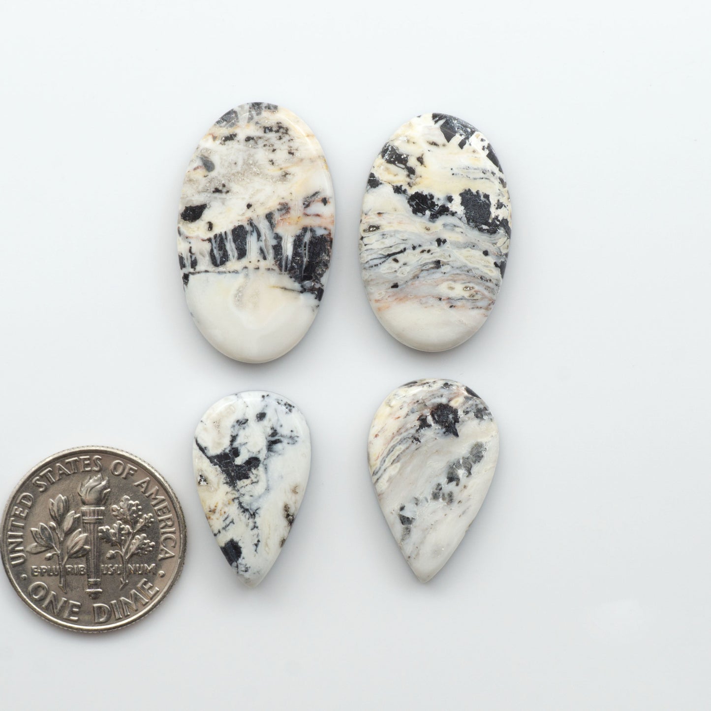 Natural White Buffalo Stone Cabochons are semi-precious gemstones cut into shapes ideal for jewelry-making, making them an excellent choice for artisans.