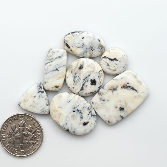 Natural White Buffalo Stone Cabochons are semi-precious gemstones cut into shapes ideal for jewelry-making, making them an excellent choice for artisans.