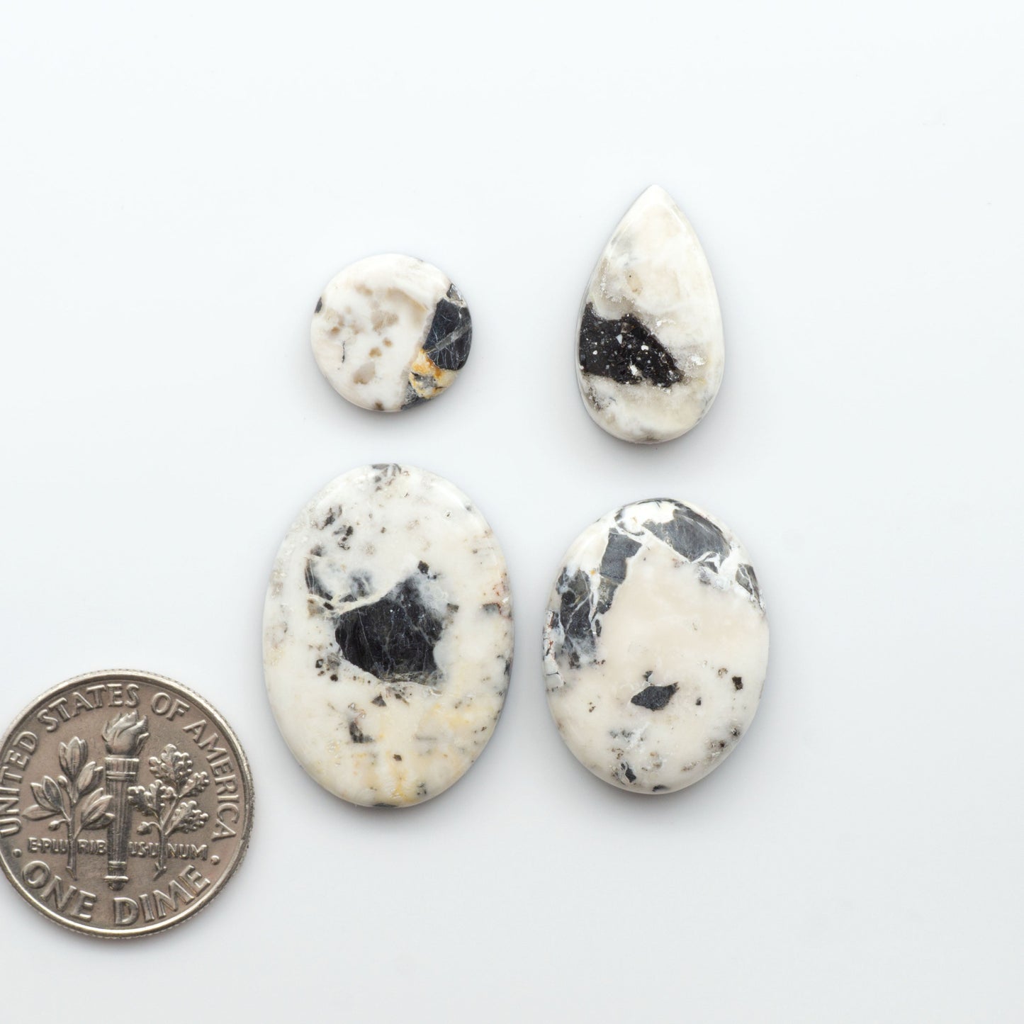 Natural White Buffalo Stone Cabochons are semi-precious gemstones cut into shapes ideal for jewelry-making, making them an excellent choice for artisans.