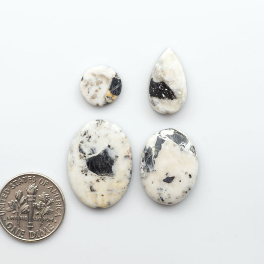 Natural White Buffalo Stone Cabochons are semi-precious gemstones cut into shapes ideal for jewelry-making, making them an excellent choice for artisans.