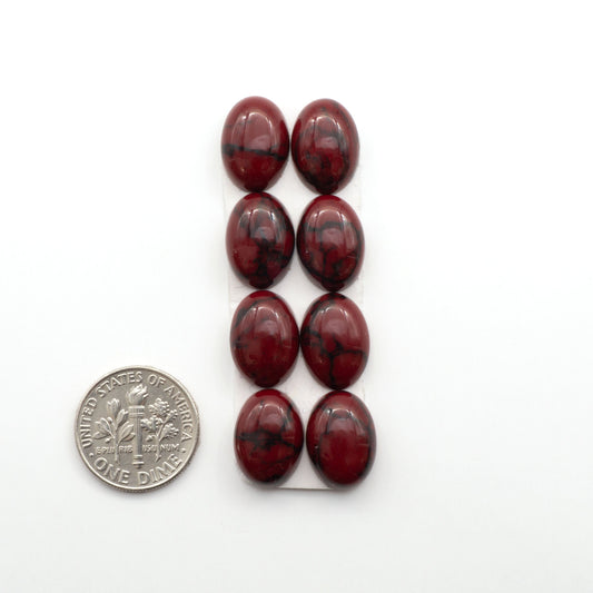 Bloody Bison Jasper is a composite stone with a vibrant red hue and black matrix that creates a strong impression and a touch of opulence to any jewelry piece.