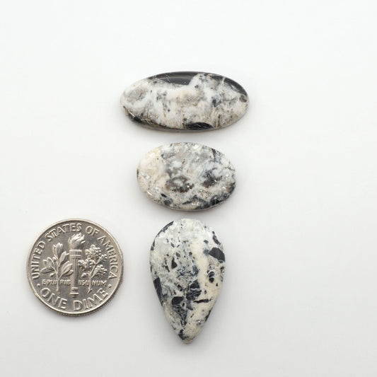 Natural White Buffalo Stone Cabochons are semi-precious gemstones cut into shapes ideal for jewelry-making, making them an excellent choice for artisans.