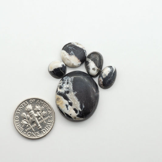 Natural White Buffalo Stone Cabochons are semi-precious gemstones cut into shapes ideal for jewelry-making, making them an excellent choice for artisans.