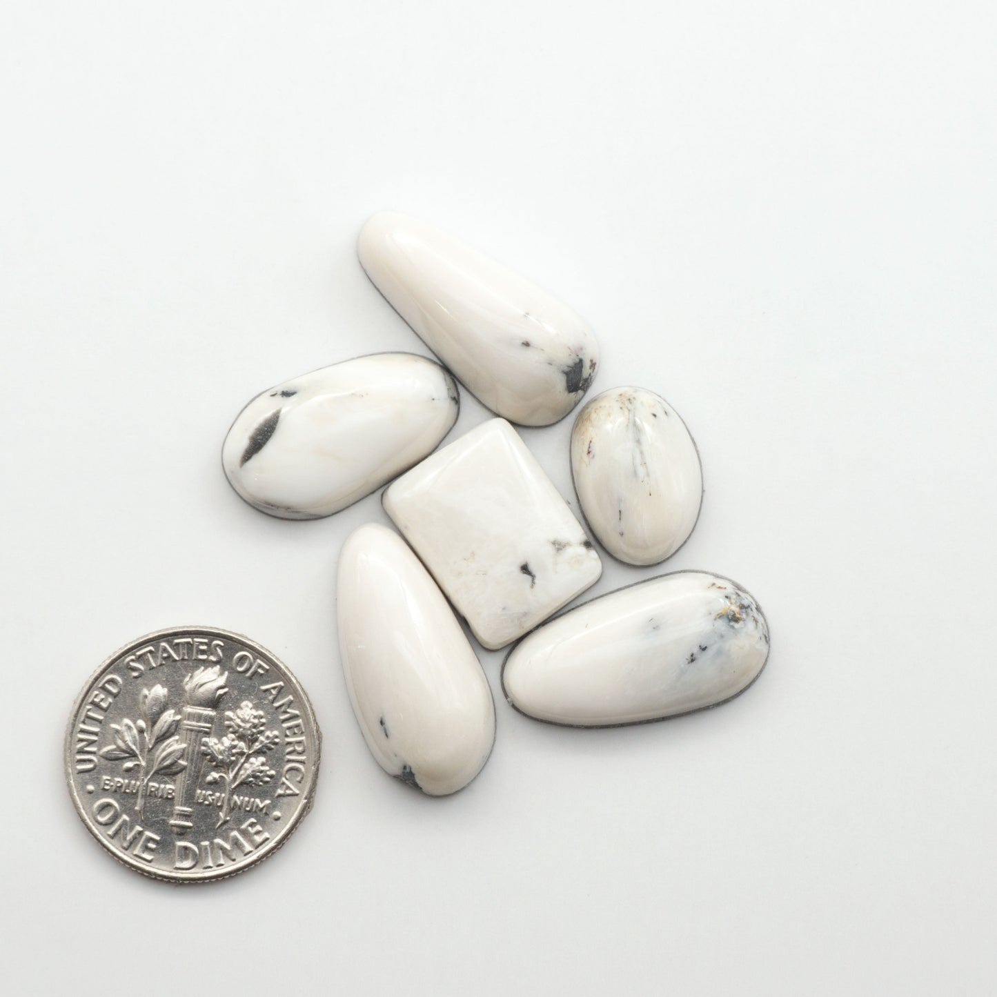 Natural White Buffalo Stone Cabochons are semi-precious gemstones cut into shapes ideal for jewelry-making, making them an excellent choice for artisans.
