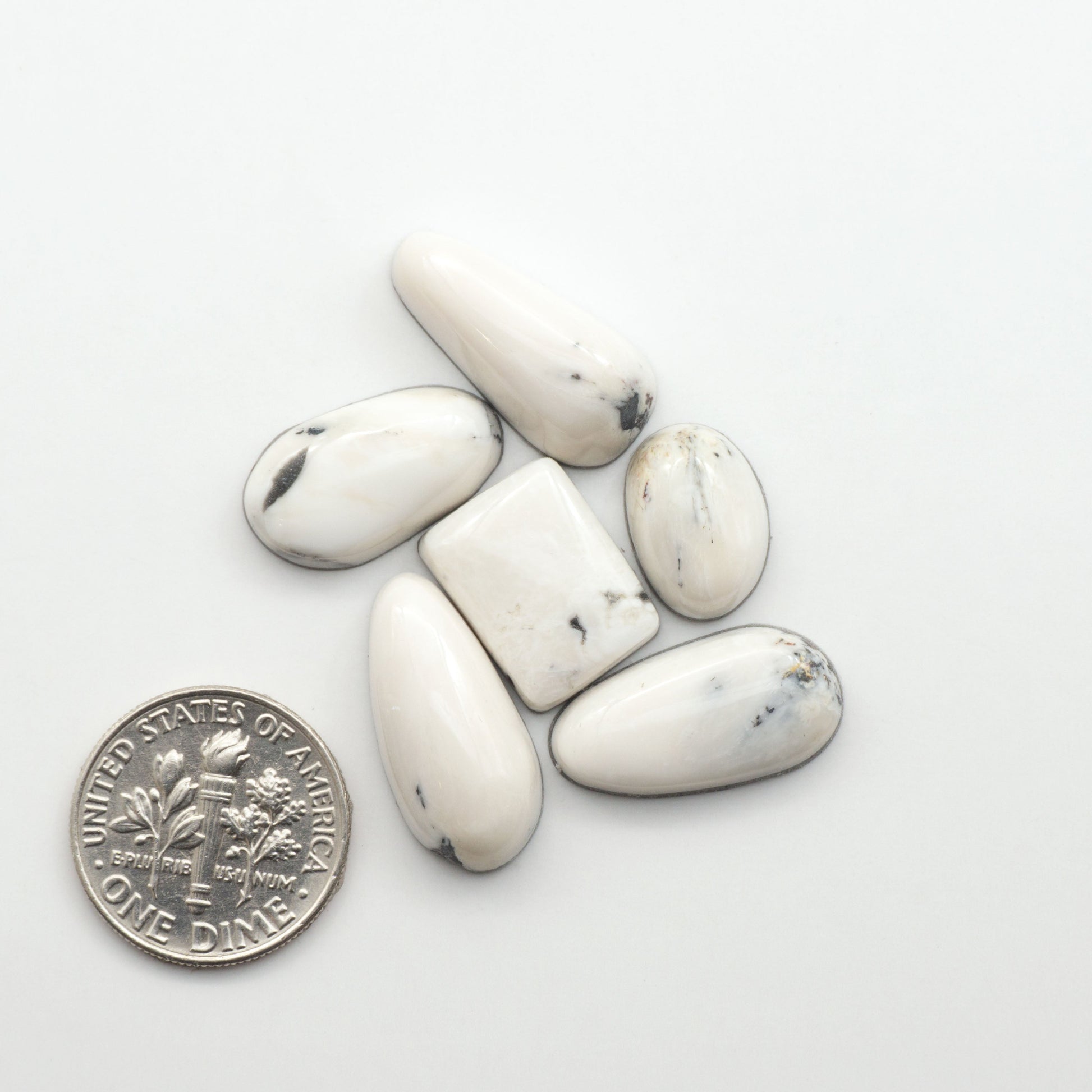 Natural White Buffalo Stone Cabochons are semi-precious gemstones cut into shapes ideal for jewelry-making, making them an excellent choice for artisans.