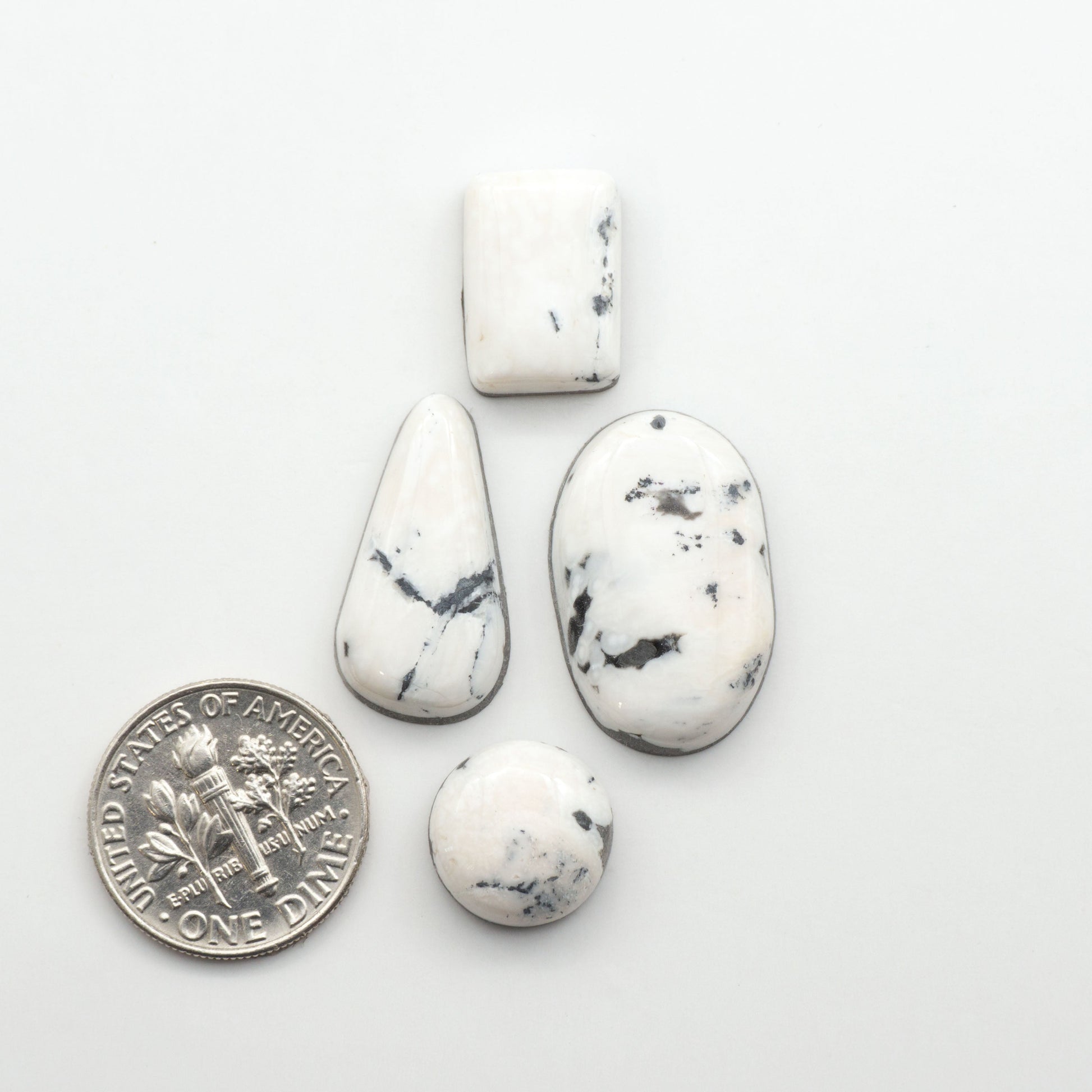 Natural White Buffalo Stone Cabochons are semi-precious gemstones cut into shapes ideal for jewelry-making, making them an excellent choice for artisans.