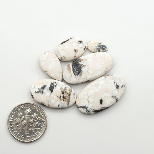 Natural White Buffalo Stone Cabochons are semi-precious gemstones cut into shapes ideal for jewelry-making, making them an excellent choice for artisans.