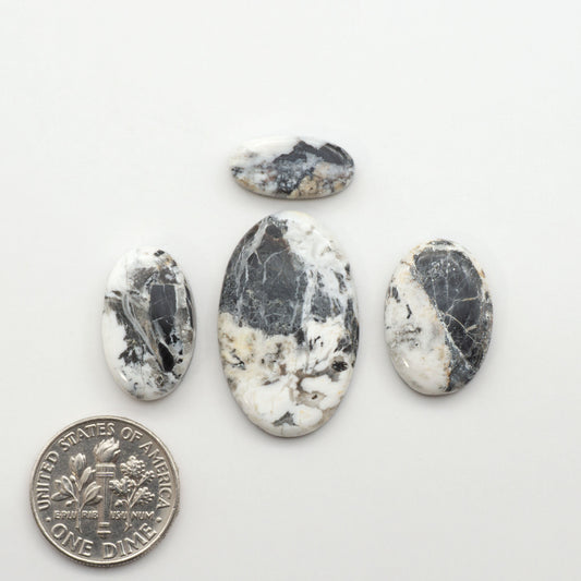 Natural White Buffalo Stone Cabochons are semi-precious gemstones cut into shapes ideal for jewelry-making, making them an excellent choice for artisans.