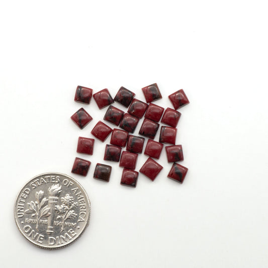 Bloody Bison Jasper is a composite stone with a vibrant red hue and black matrix that creates a strong impression and a touch of opulence to any jewelry piece.