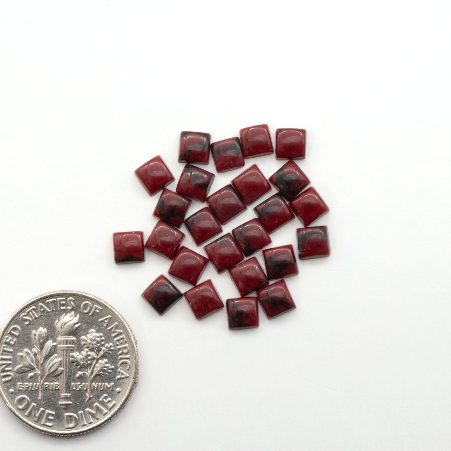 Bloody Bison Jasper is a composite stone with a vibrant red hue and black matrix that creates a strong impression and a touch of opulence to any jewelry piece.