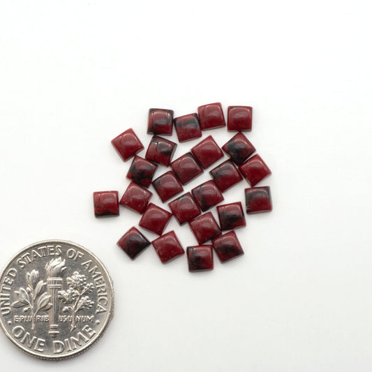 Bloody Bison Jasper is a composite stone with a vibrant red hue and black matrix that creates a strong impression and a touch of opulence to any jewelry piece.