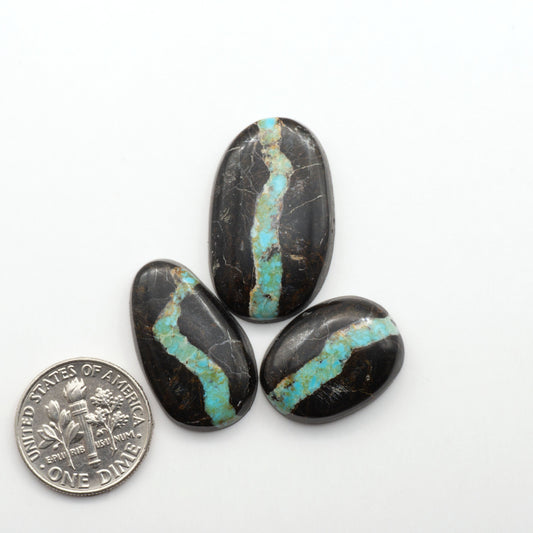 Black Jack Turquoise features a bold black color with striking veins of turquoise, making it a truly one-of-a-kind addition to your jewelry collection. 