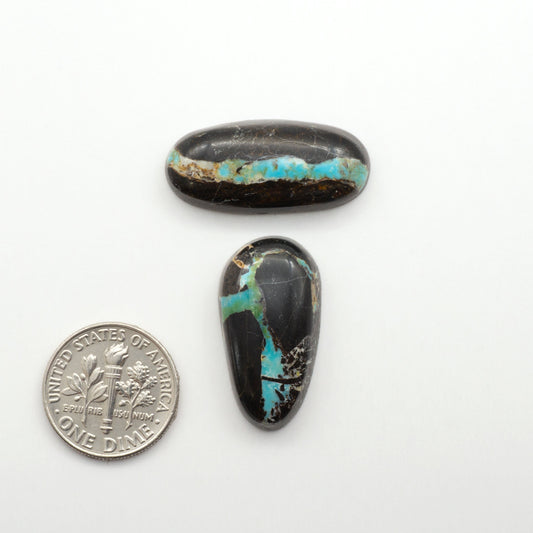Black Jack Turquoise features a bold black color with striking veins of turquoise, making it a truly one-of-a-kind addition to your jewelry collection.

