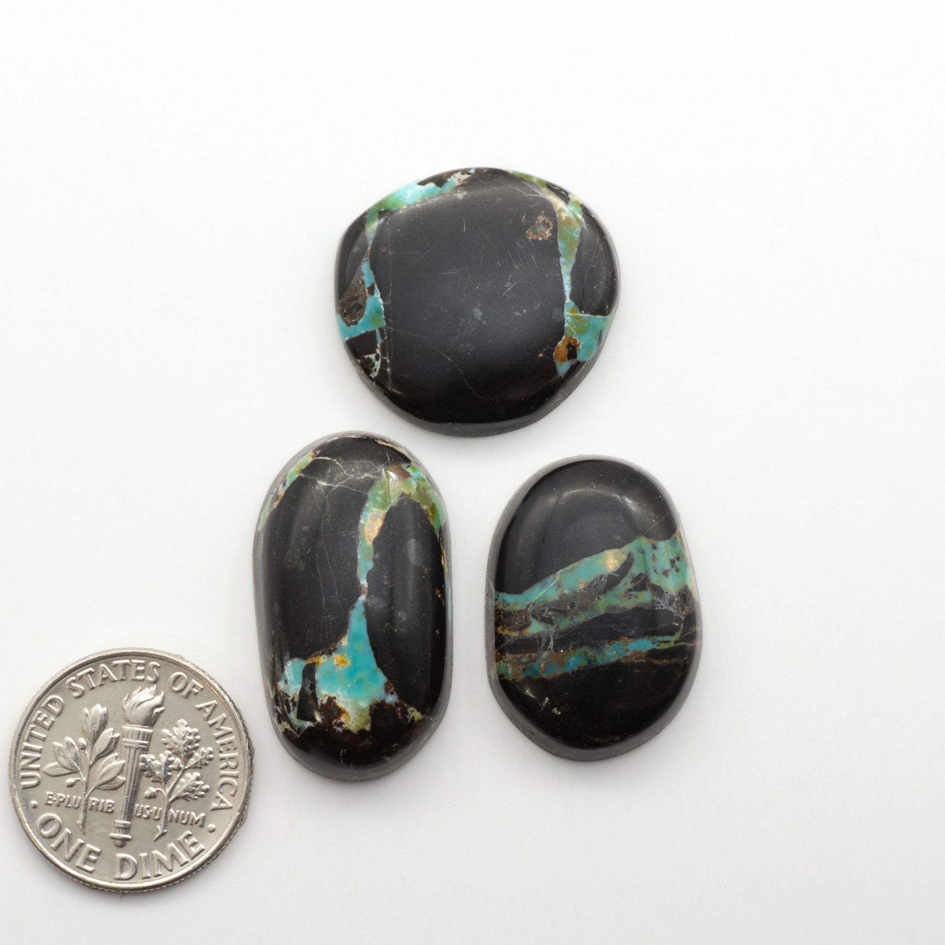 Black Jack Turquoise features a bold black color with striking veins of turquoise, making it a truly one-of-a-kind addition to your jewelry collection.

