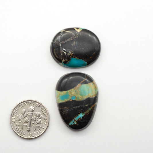 Black Jack Turquoise features a bold black color with striking veins of turquoise, making it a truly one-of-a-kind addition to your jewelry collection.

