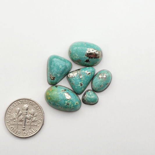 Nacozari turquoise cabochons are striking gemstones known for their vibrant blue to greenish-blue colors and pyrite, these stones are prized in jewelry making.