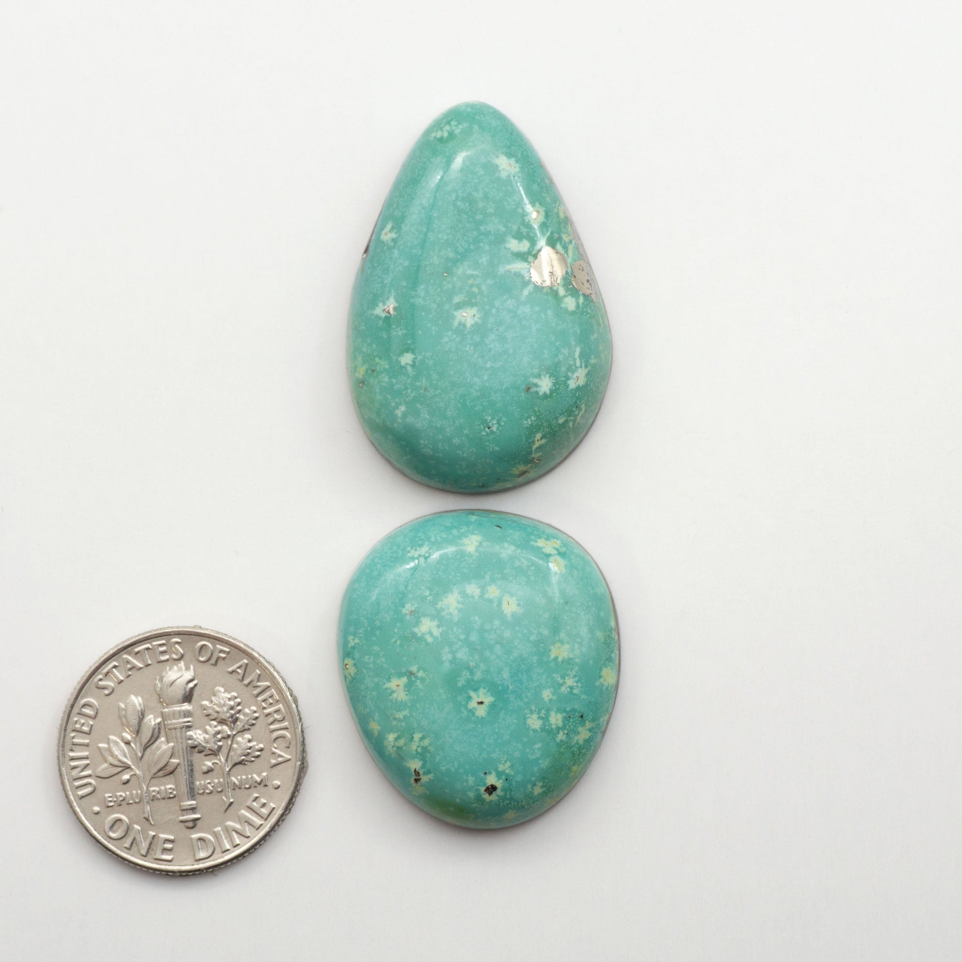 Nacozari turquoise cabochons are striking gemstones known for their vibrant blue to greenish-blue colors and pyrite, these stones are prized in jewelry making.