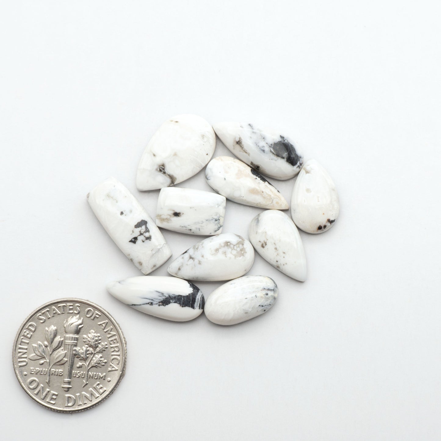 Natural White Buffalo Stone Cabochons are semi-precious gemstones cut into shapes ideal for jewelry-making, making them an excellent choice for artisans.