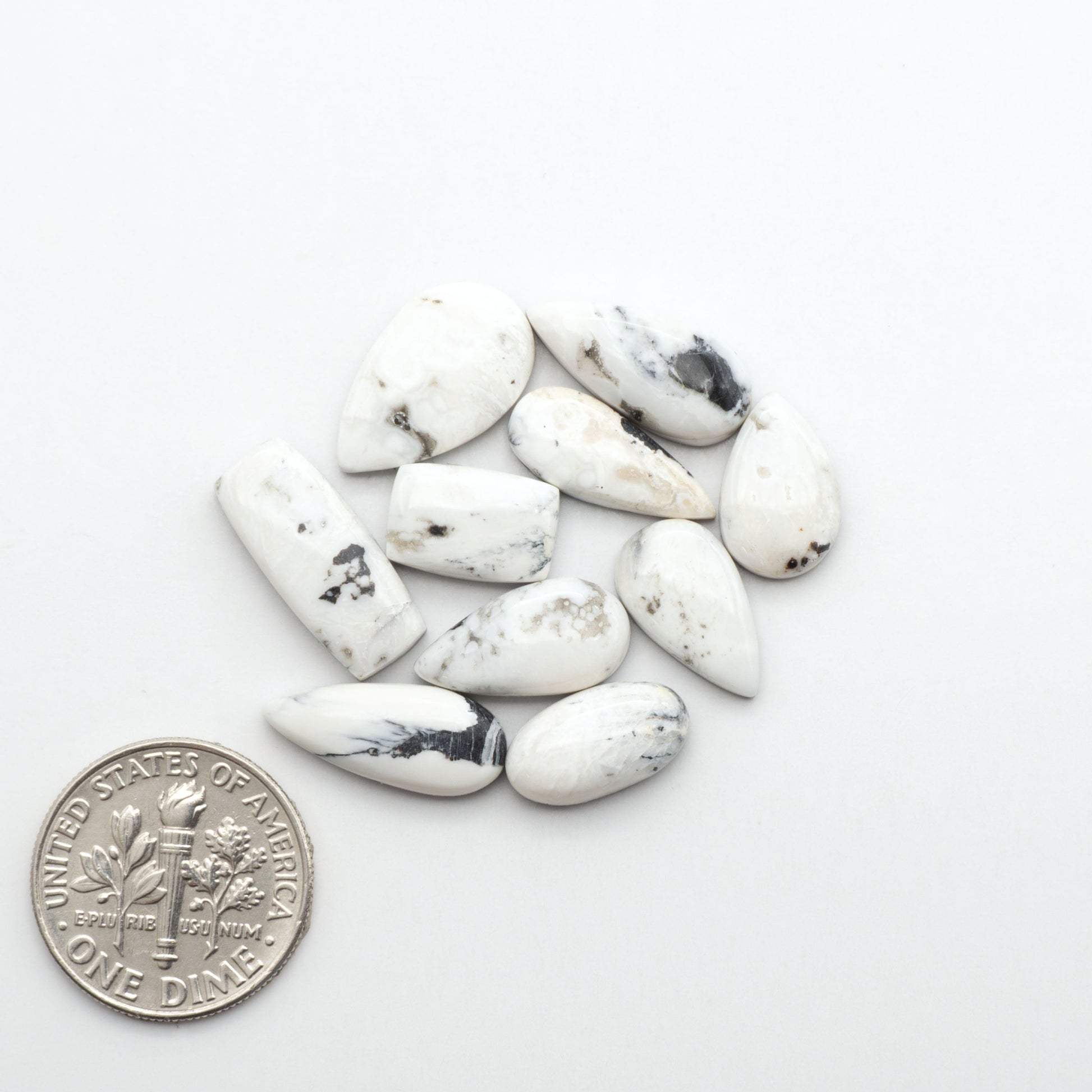 Natural White Buffalo Stone Cabochons are semi-precious gemstones cut into shapes ideal for jewelry-making, making them an excellent choice for artisans.