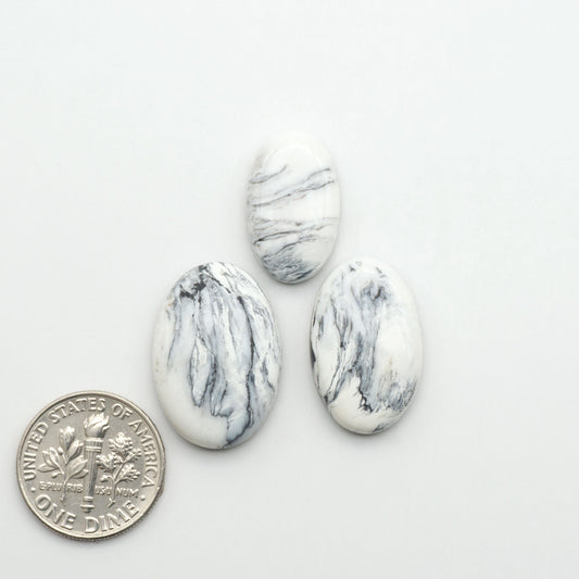 Natural White Buffalo Stone Cabochons are semi-precious gemstones cut into shapes ideal for jewelry-making, making them an excellent choice for artisans.