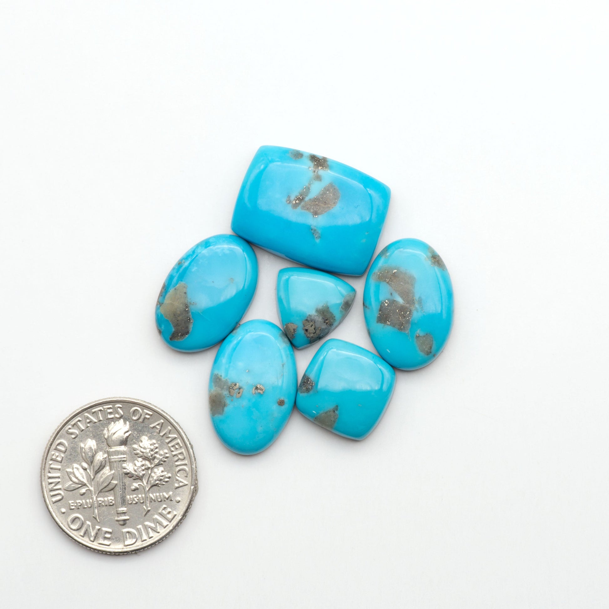 Nacozari turquoise cabochons are striking gemstones known for their vibrant blue to greenish-blue colors and pyrite, these stones are prized in jewelry making.