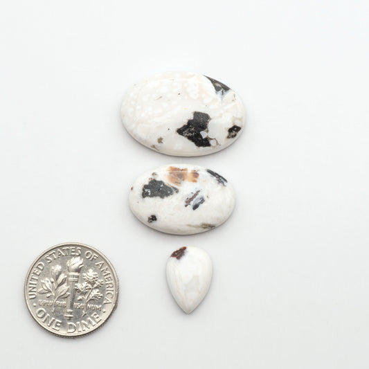 Natural White Buffalo Stone Cabochons are semi-precious gemstones cut into shapes ideal for jewelry-making, making them an excellent choice for artisans.