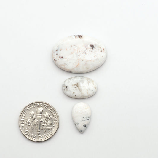 Natural White Buffalo Stone Cabochons are semi-precious gemstones cut into shapes ideal for jewelry-making, making them an excellent choice for artisans.