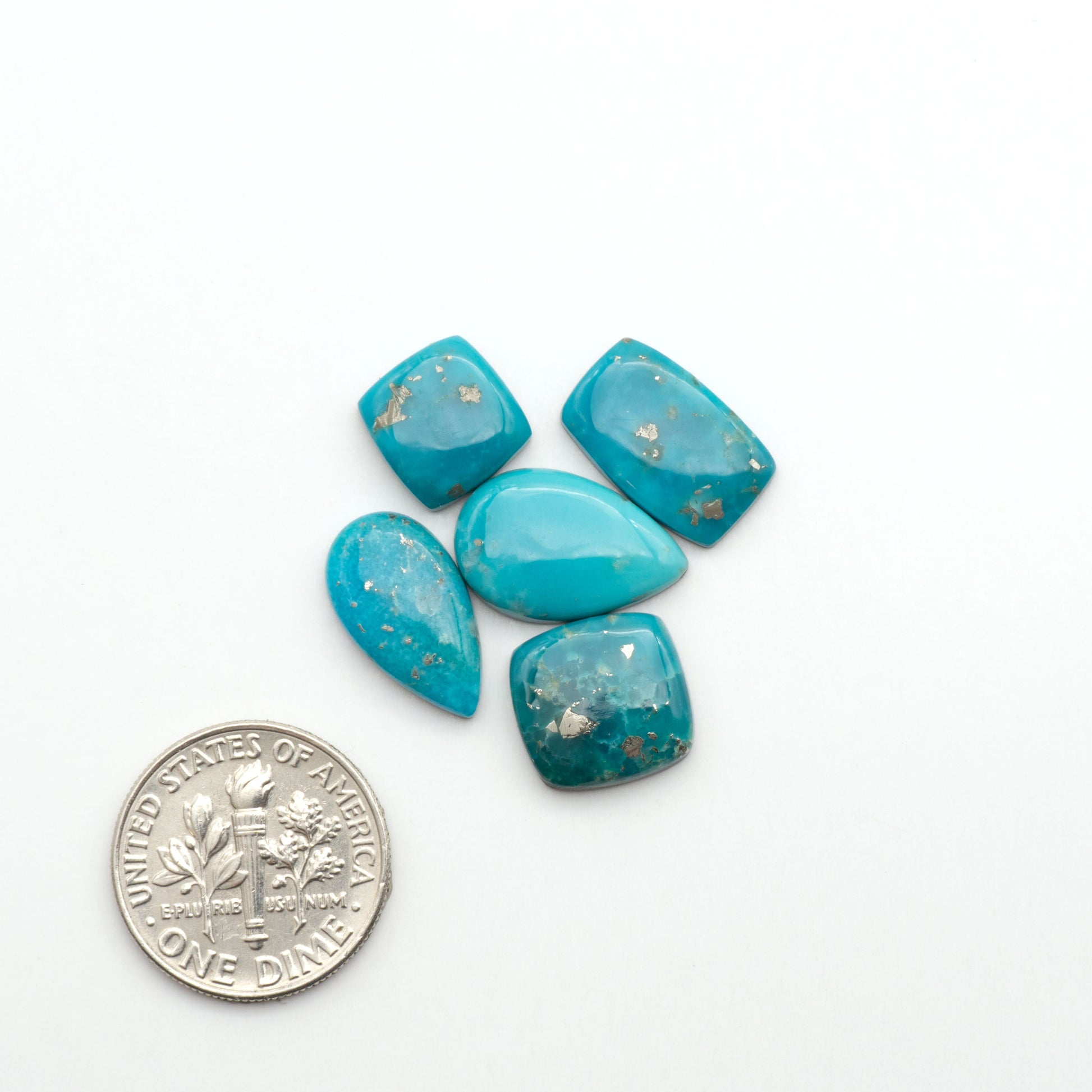 Nacozari turquoise cabochons are striking gemstones known for their vibrant blue to greenish-blue colors and pyrite, these stones are prized in jewelry making.