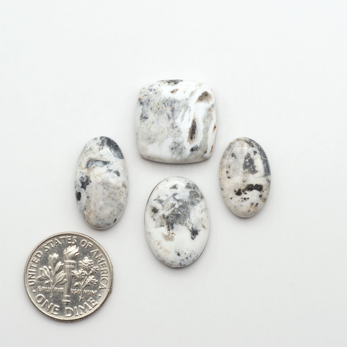Natural White Buffalo Stone Cabochons are semi-precious gemstones cut into shapes ideal for jewelry-making, making them an excellent choice for artisans.