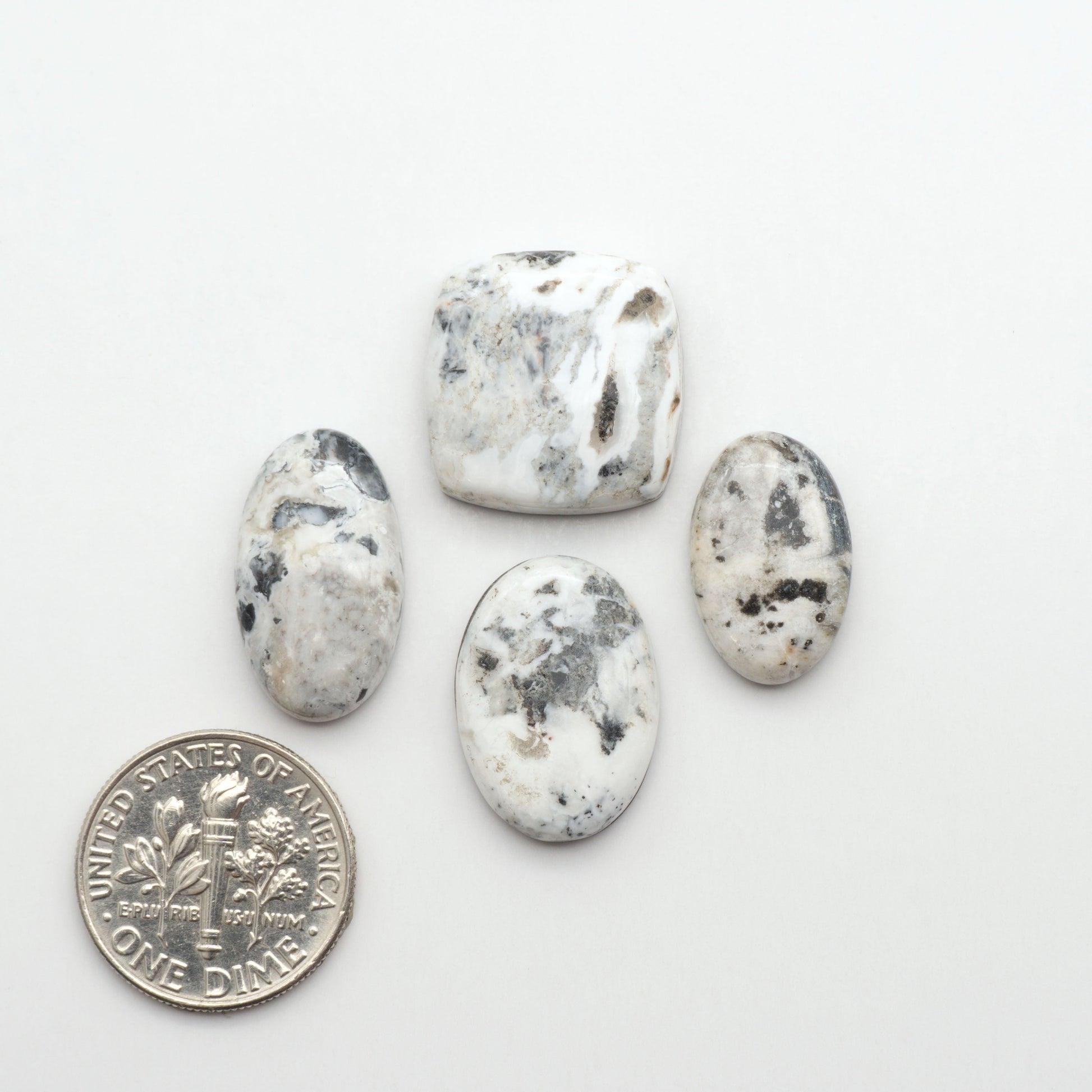 Natural White Buffalo Stone Cabochons are semi-precious gemstones cut into shapes ideal for jewelry-making, making them an excellent choice for artisans.