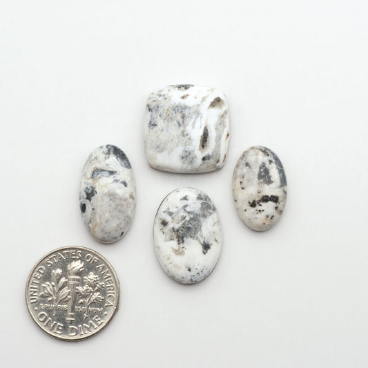 Natural White Buffalo Stone Cabochons are semi-precious gemstones cut into shapes ideal for jewelry-making, making them an excellent choice for artisans.