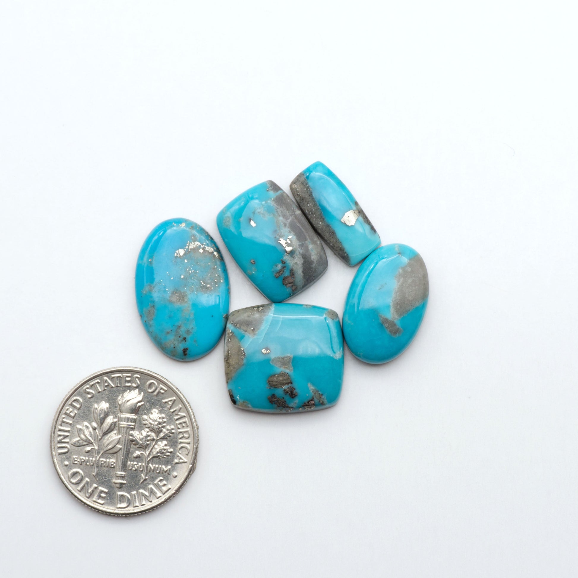 Nacozari turquoise cabochons are striking gemstones known for their vibrant blue to greenish-blue colors and pyrite, these stones are prized in jewelry making.