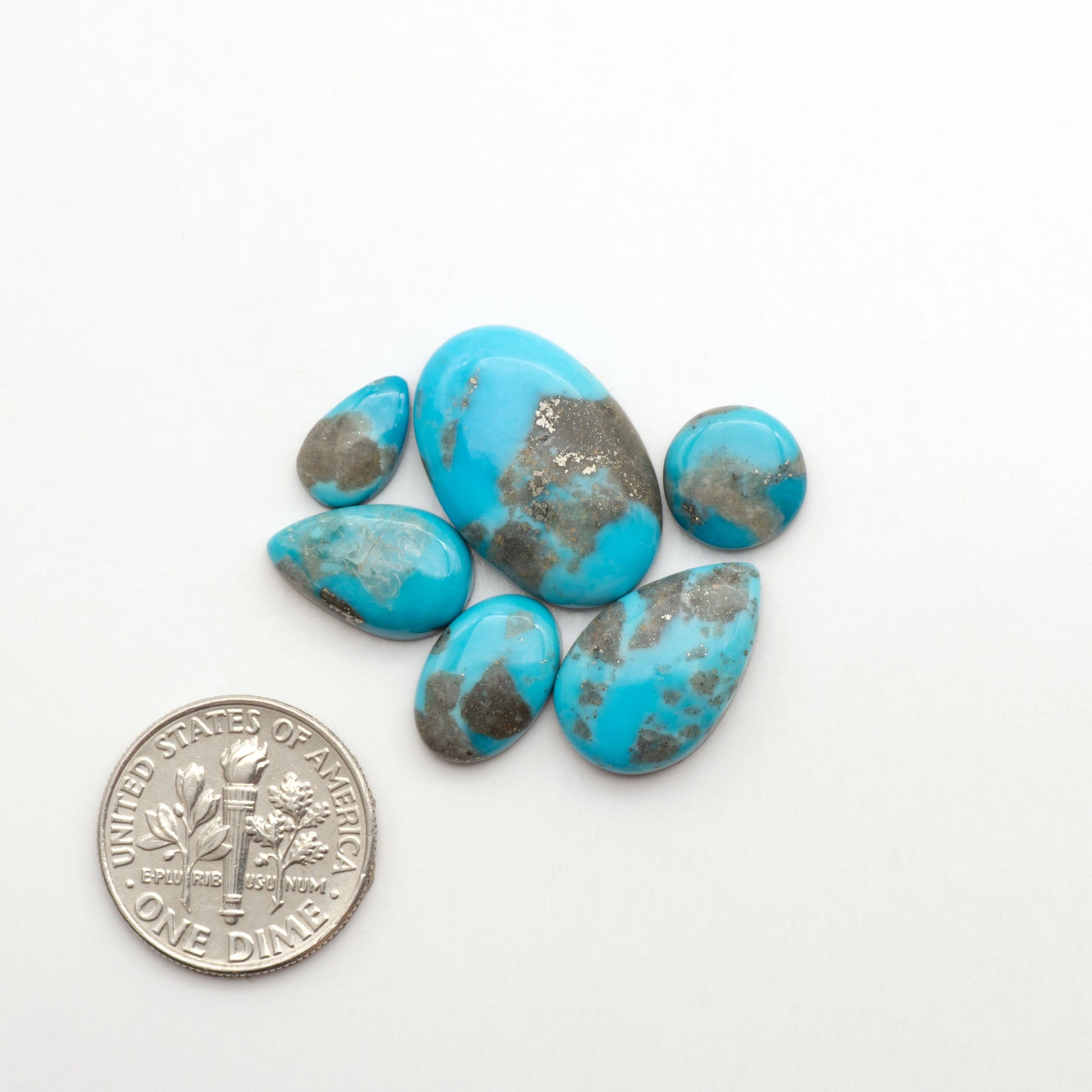 Nacozari turquoise cabochons are striking gemstones known for their vibrant blue to greenish-blue colors and pyrite, these stones are prized in jewelry making.