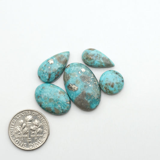 Nacozari turquoise cabochons are striking gemstones known for their vibrant blue to greenish-blue colors and pyrite, these stones are prized in jewelry making.