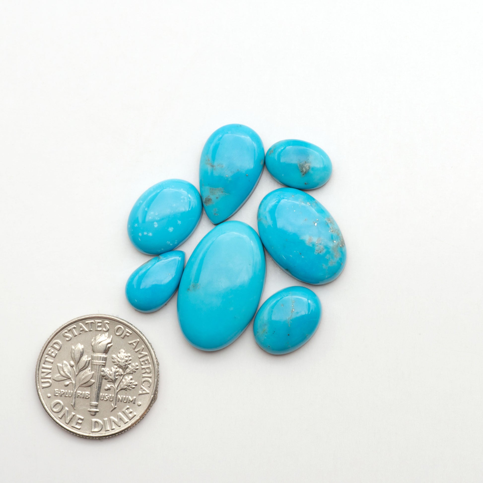 Nacozari turquoise cabochons are striking gemstones known for their vibrant blue to greenish-blue colors and pyrite, these stones are prized in jewelry making.