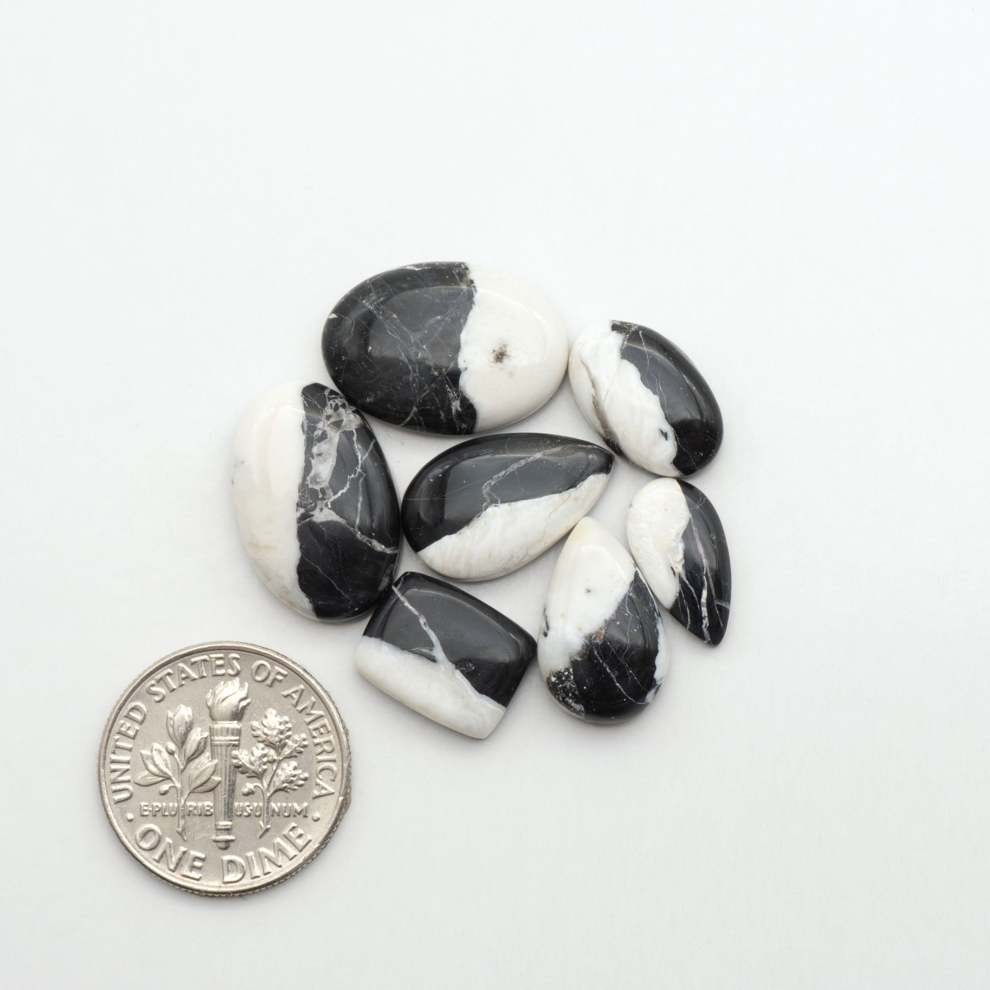 Natural White Buffalo Stone Cabochons are semi-precious gemstones cut into shapes ideal for jewelry-making, making them an excellent choice for artisans.