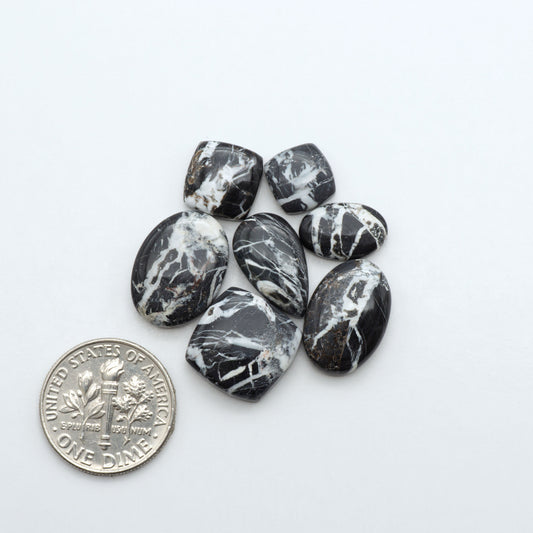 Natural White Buffalo Stone Cabochons are semi-precious gemstones cut into shapes ideal for jewelry-making, making them an excellent choice for artisans.