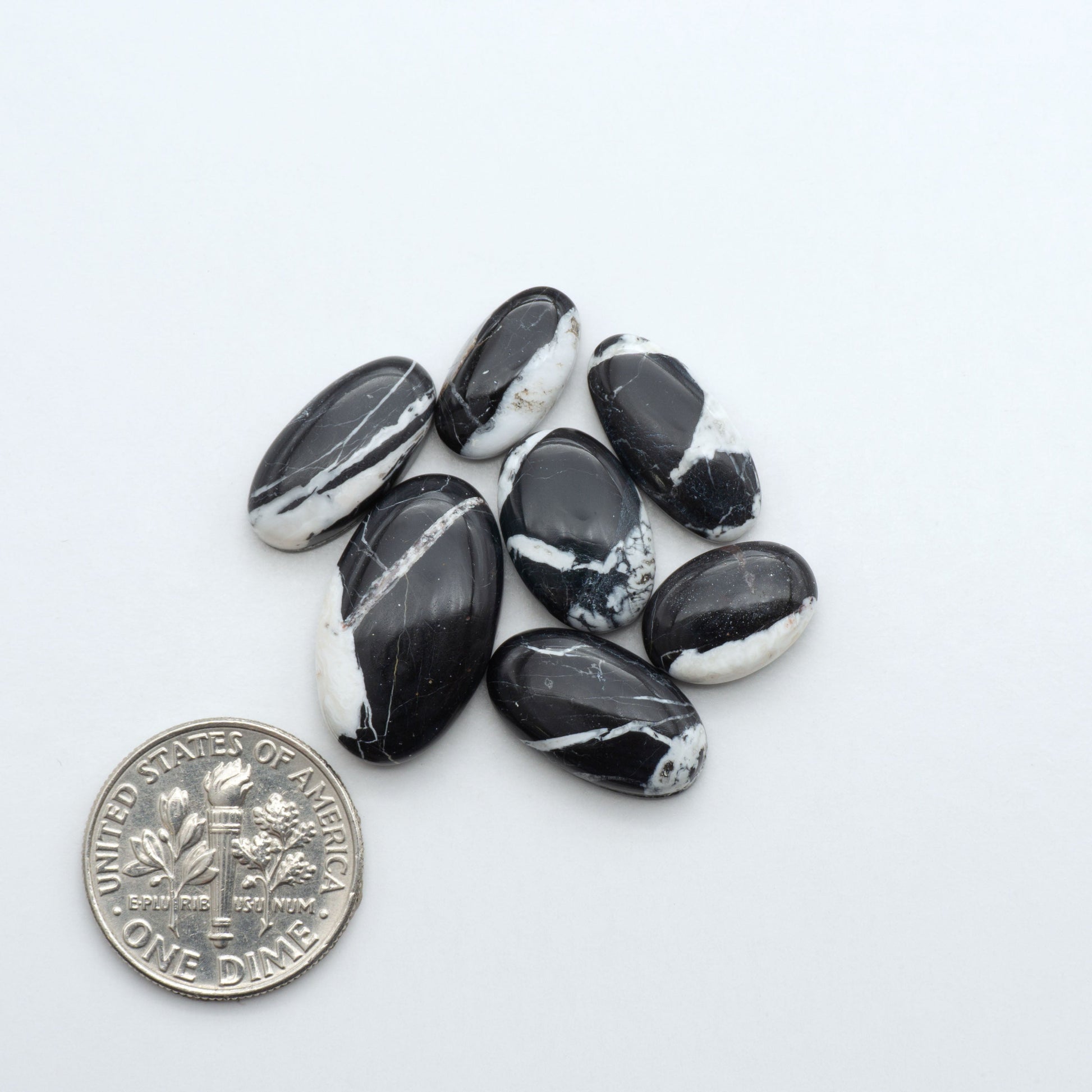Natural White Buffalo Stone Cabochons are semi-precious gemstones cut into shapes ideal for jewelry-making, making them an excellent choice for artisans.