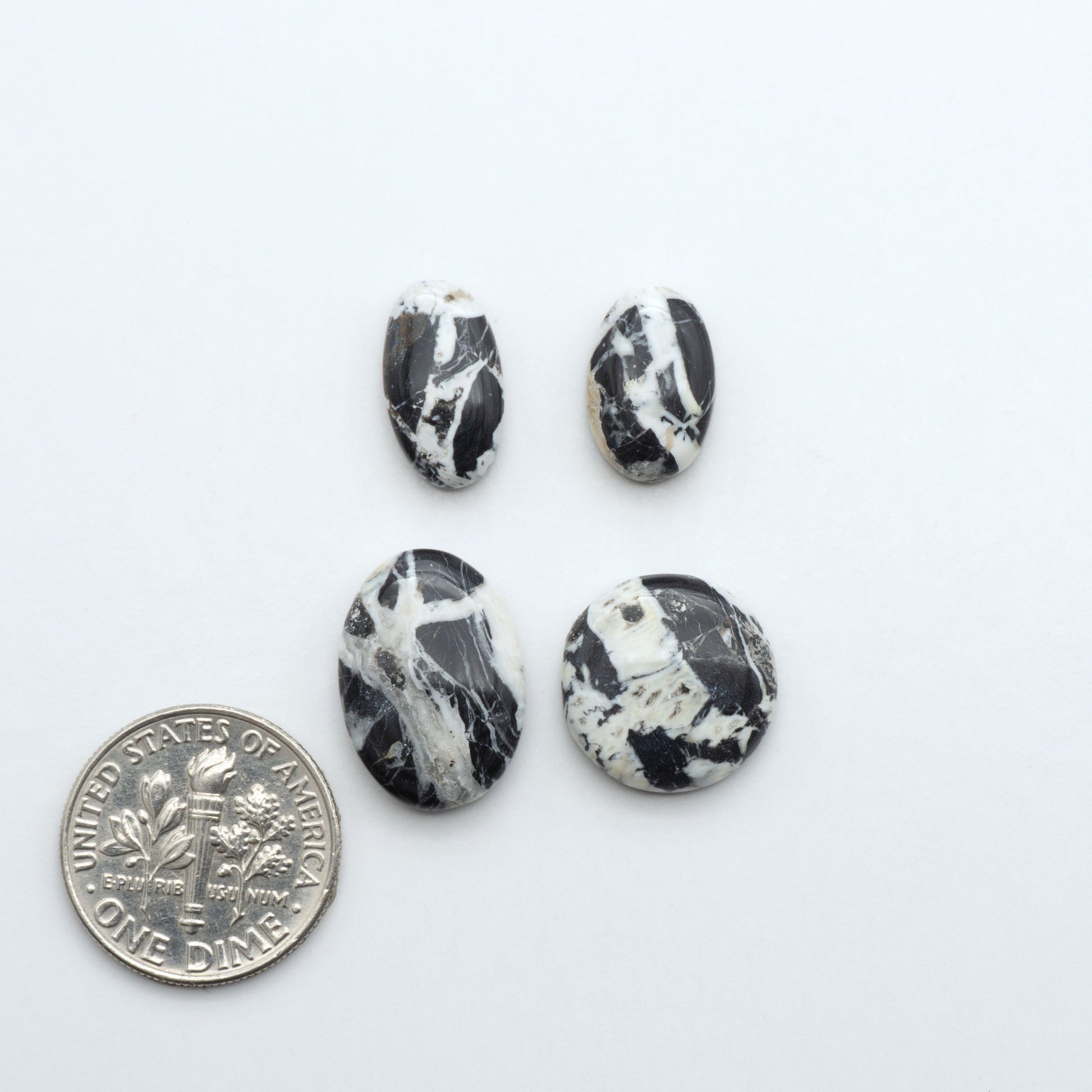 Natural White Buffalo Stone Cabochons are semi-precious gemstones cut into shapes ideal for jewelry-making, making them an excellent choice for artisans.