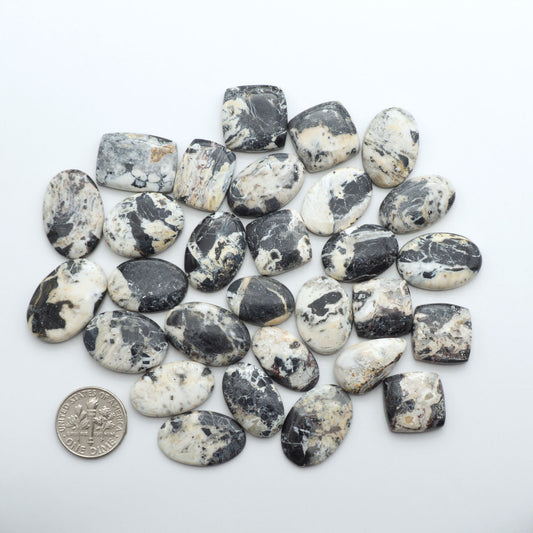 Natural White Buffalo Stone Cabochons are semi-precious gemstones cut into shapes ideal for jewelry-making, making them an excellent choice for artisans.