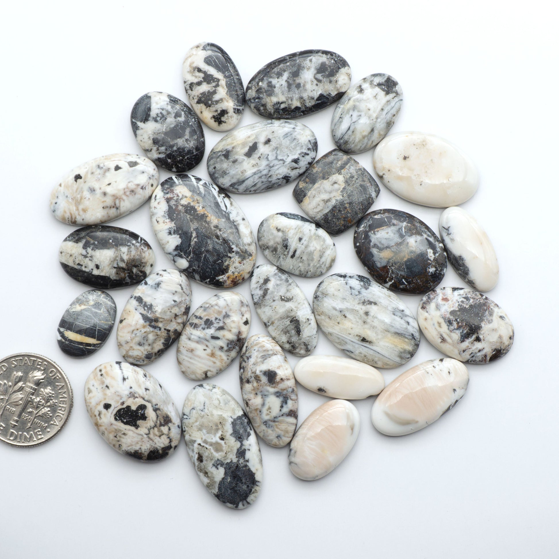 Natural White Buffalo Stone Cabochons are semi-precious gemstones cut into shapes ideal for jewelry-making, making them an excellent choice for artisans.