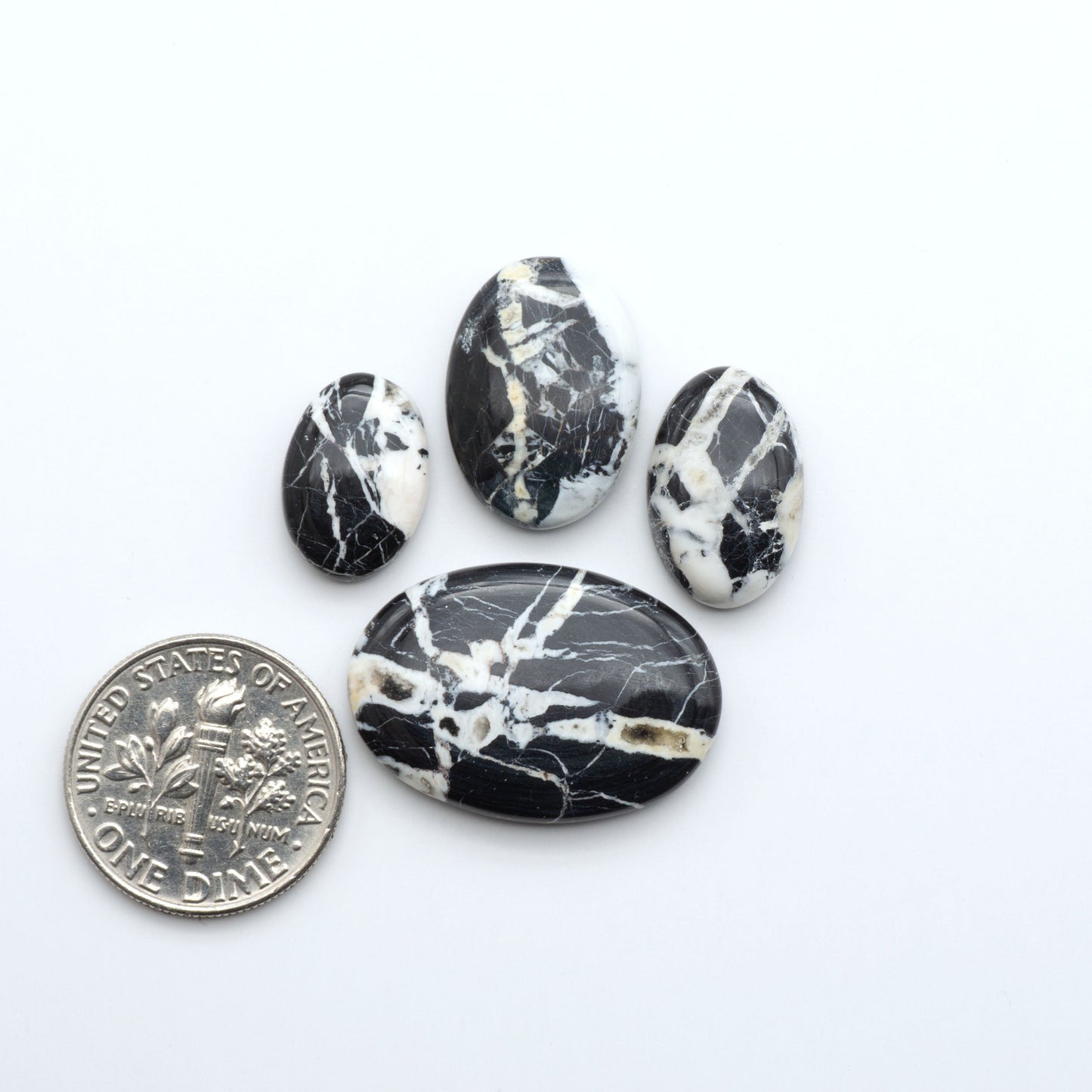 Natural White Buffalo Stone Cabochons are semi-precious gemstones cut into shapes ideal for jewelry-making, making them an excellent choice for artisans.