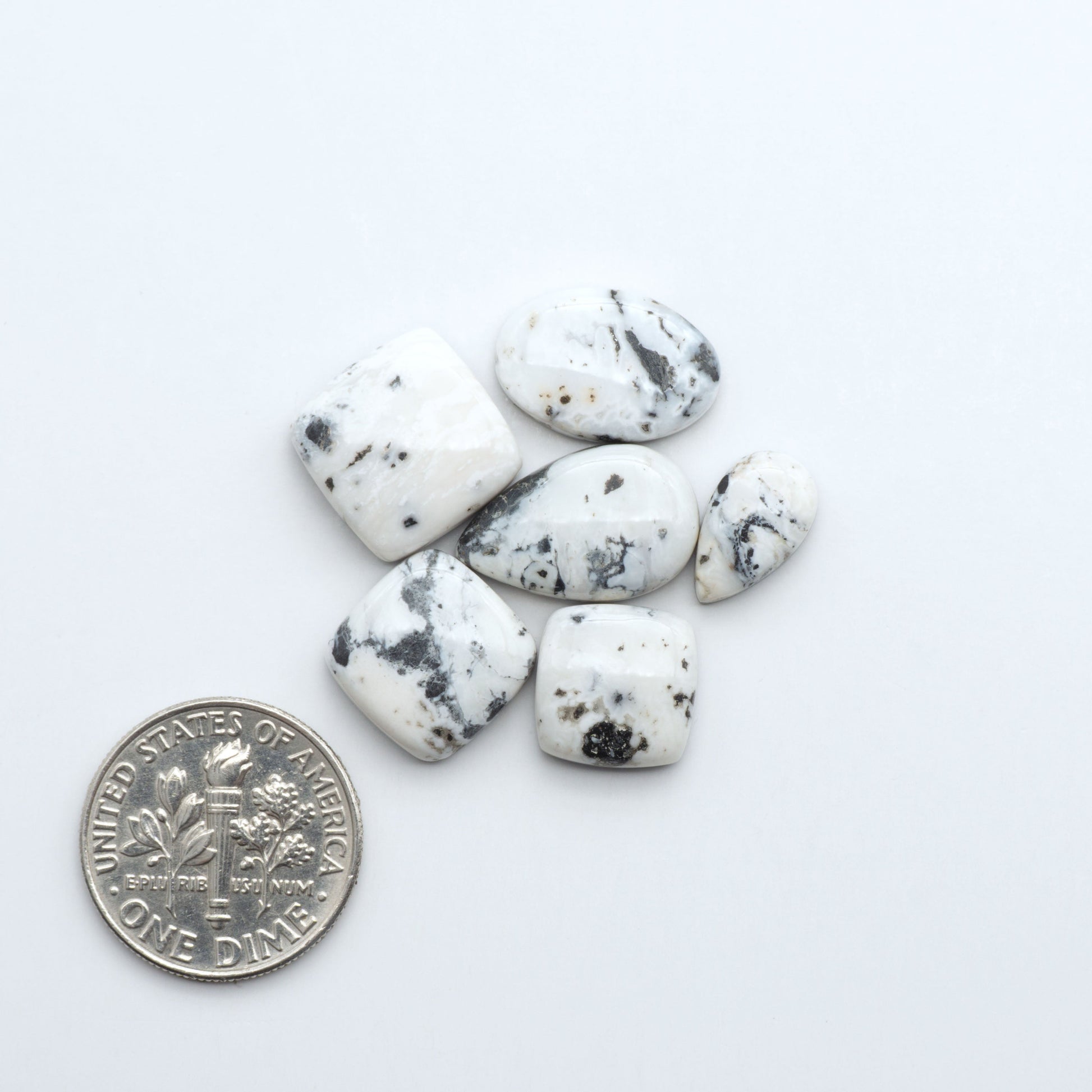 Natural White Buffalo Stone Cabochons are semi-precious gemstones cut into shapes ideal for jewelry-making, making them an excellent choice for artisans.