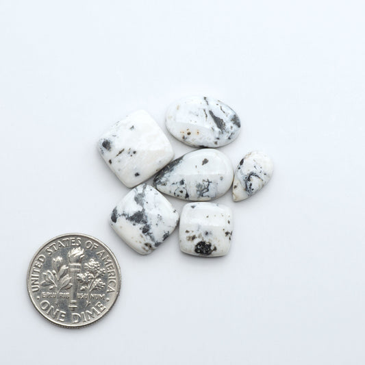 Natural White Buffalo Stone Cabochons are semi-precious gemstones cut into shapes ideal for jewelry-making, making them an excellent choice for artisans.