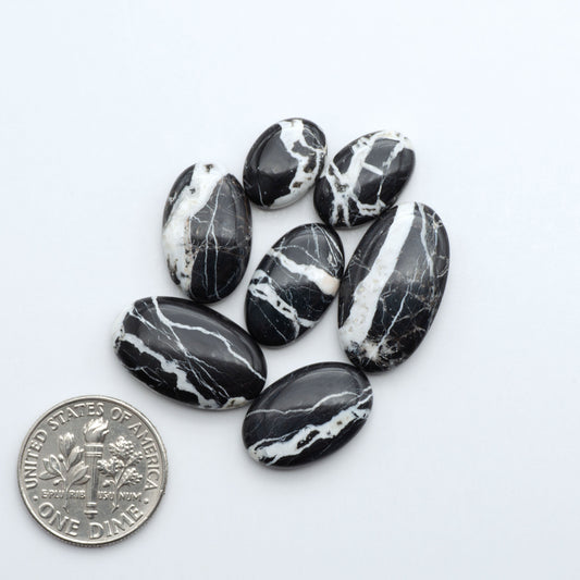 Natural White Buffalo Stone Cabochons are semi-precious gemstones cut into shapes ideal for jewelry-making, making them an excellent choice for artisans.