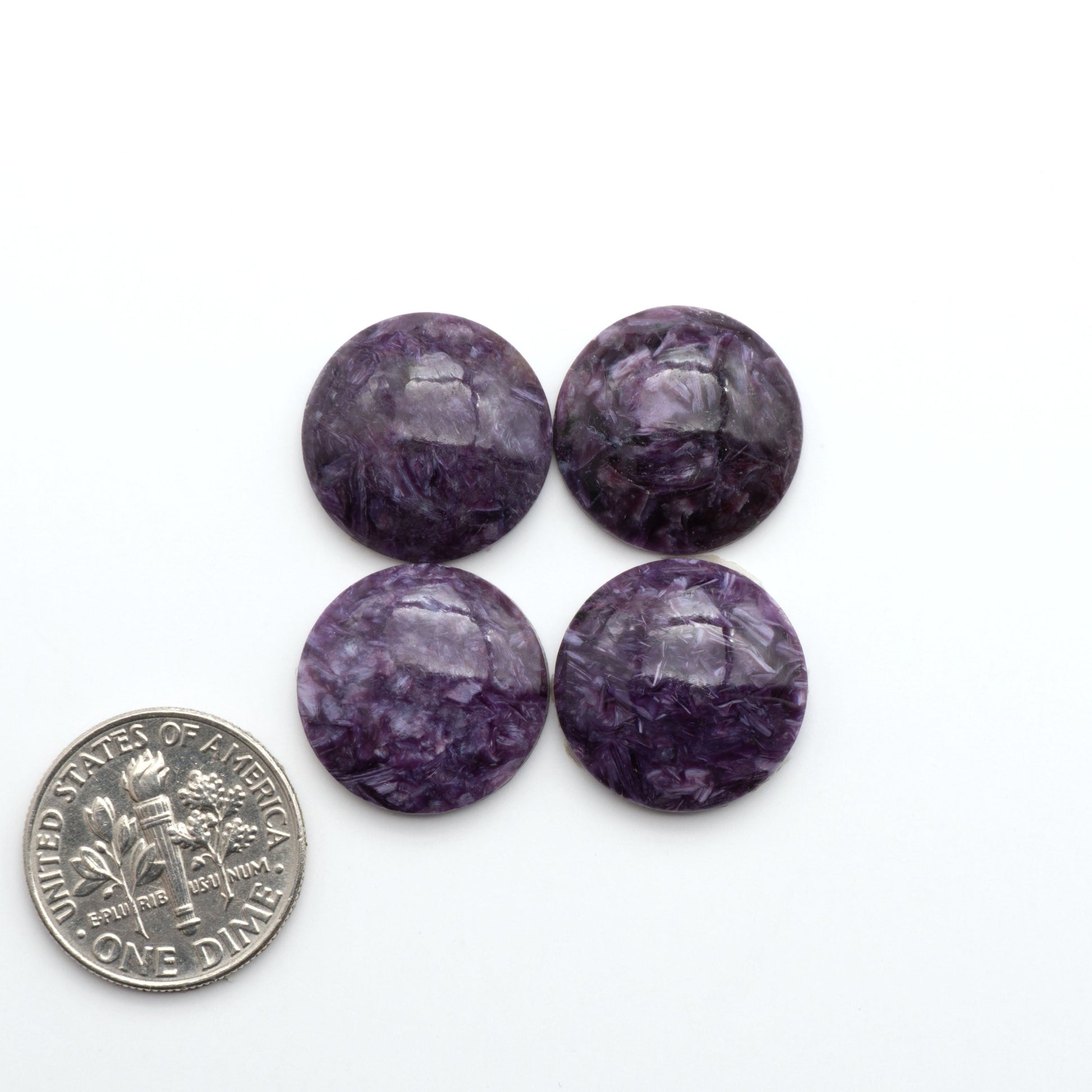 Shop natural Charoite cabochons with vivid violet swirls, perfect for jewelry makers and silversmiths creating rings, pendants, and custom designs.