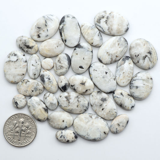Natural White Buffalo Stone Cabochons are semi-precious gemstones cut into shapes ideal for jewelry-making, making them an excellent choice for artisans.